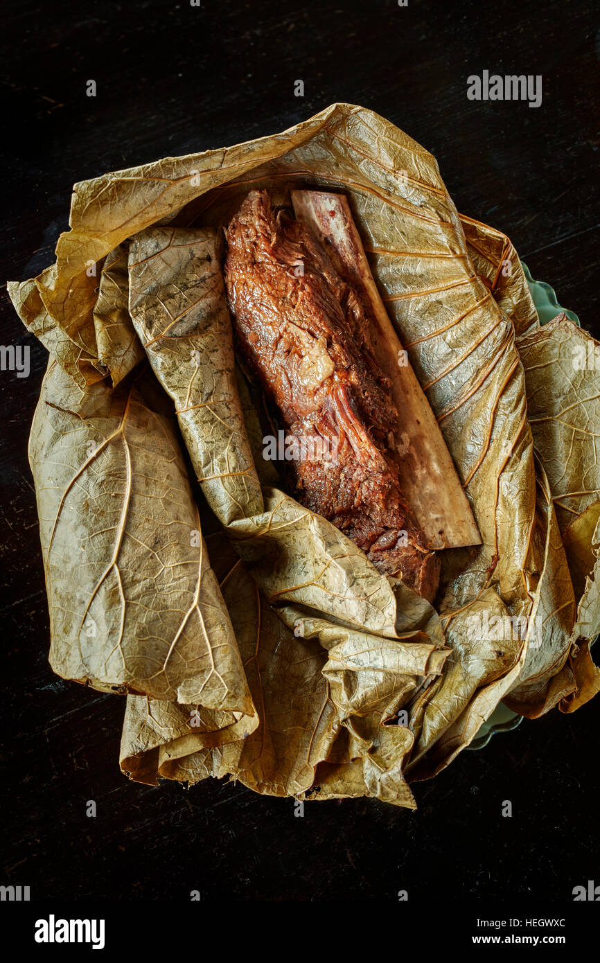 Cinese cotte lentamente la nervatura di carni bovine confezionate in lotus leaf settentrionale piatto cinese Hutong Shard ristorante Foto Stock