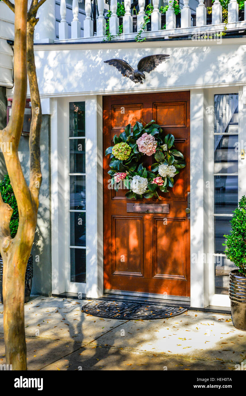 Bella corona decorativa di ortensie sulla porta di legno della casa coloniale con eagle nel centro storico di Charleston, Sc Foto Stock