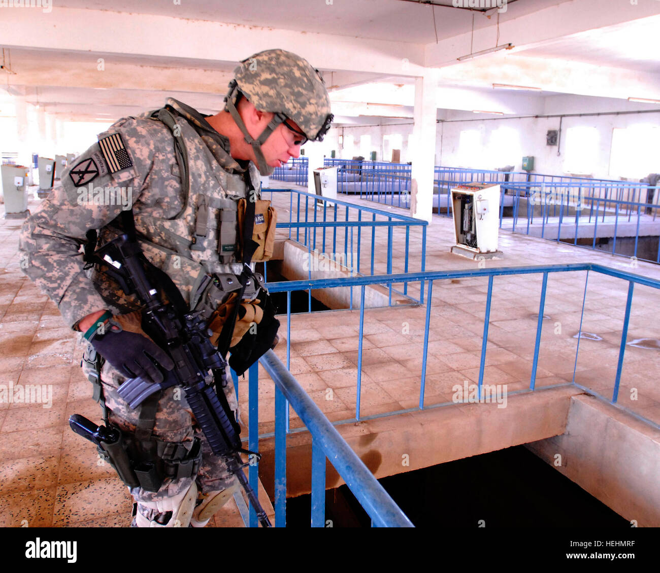 Il personale Sgt. Douglas re, da Spokane, Washington, il team sergente per gli affari civili Team 32, fissata per il 2° Battaglione, 6° Reggimento di Fanteria, 2° Brigata Team di combattimento, 1° Divisione Corazzate, Divisione multinazionale- Baghdad, controlla i sistemi di filtrazione a Bawi pompa acqua e impianto di filtro in Salman Pak prima della pianta riapertura cerimonia, Dic 13. Bawi acqua si apre in Salman Pak 136511 Foto Stock