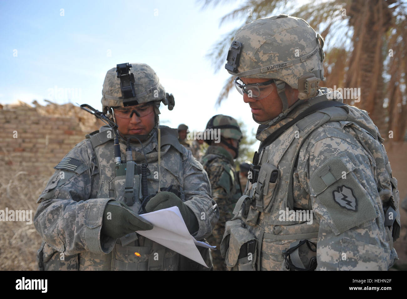 Stati Uniti Il personale dell'esercito Sgt. Oscar Lucero da Plainview, Texas, e Sgt Jessy Martinez di Los Angeles, California, di alfa batteria, primo plotone, 2° Battaglione, 8 campo reggimento di artiglieria, 1° Stryker Brigade Combat Team, rivedere una mappa della zona che deve essere cancellata, 19 dic. Gli Stati Uniti Esercito è la collaborazione con l'esercito iracheno per cancellare i villaggi di Naqib e Bey'a e interrompere il flusso di al-Qaida reti e memorizza nella cache le armi in ed intorno a l'Diyala provincia dell'Iraq. Pattuglia in Diyala Provincia di Iraq 139665 Foto Stock