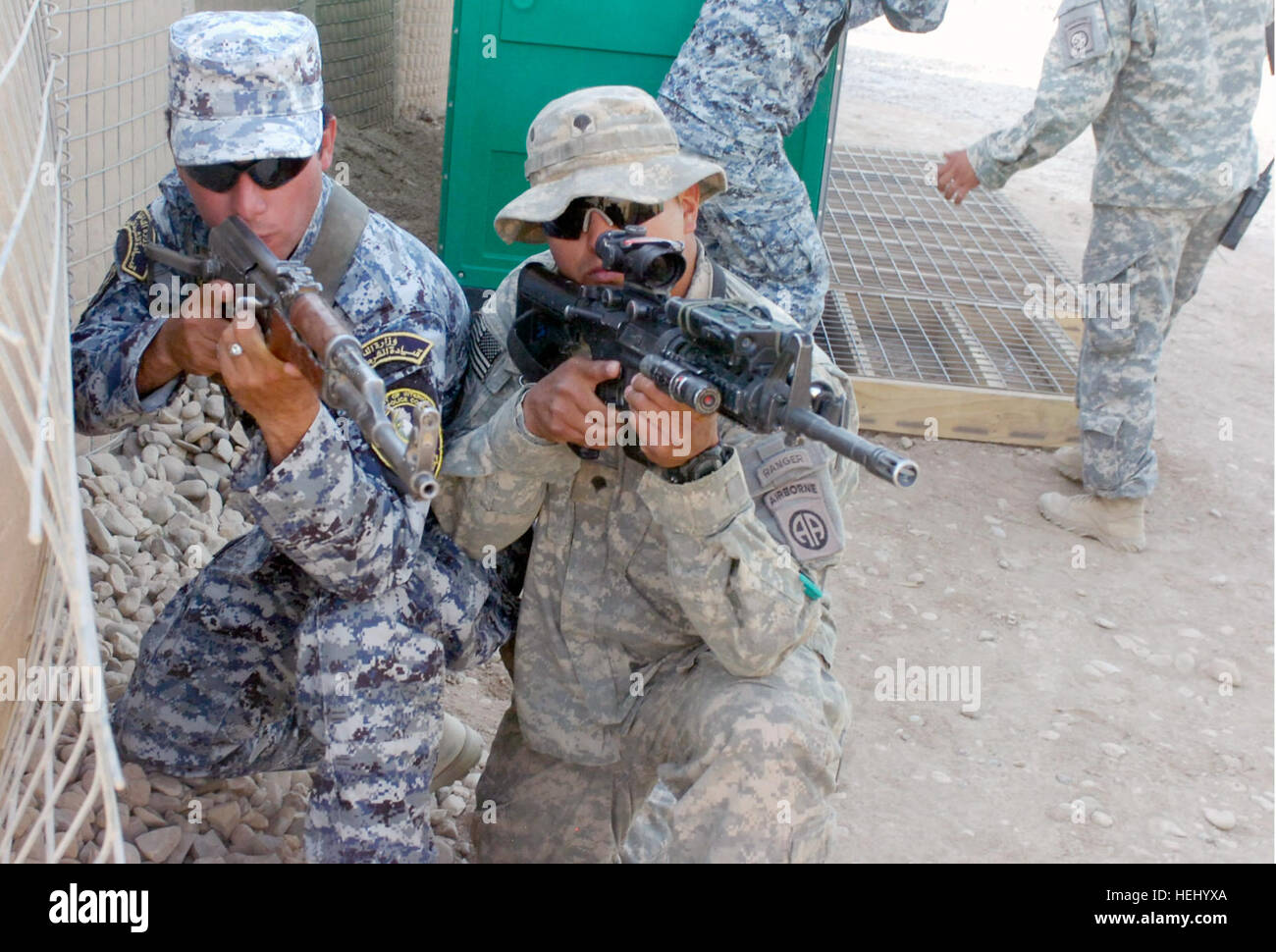 Spc. Miguel Angel Trevino, di Uvalde, Texas, assegnato alla truppa K, 5° Stormo, 73rd cavalleria, ottantaduesima Airborne Division, Division-Baghdad multinazionali, mostra nazionale di un funzionario di polizia assegnato al 3° NP brigata, 1° Divisione NP il modo corretto di tenere la sua arma durante un evento di formazione giugno 24 a inoltrare una base operativa martello, l'Iraq, che si trova al di fuori dell'est di Baghdad. L'evento di formazione è parte dello squadrone di nuova concezione "Panther Recon Training Academy". Le due settimane di academy i treni e le guide lo squadrone di Forze di Sicurezza Irachene partner su base abilità di soldato come leader di truppa Foto Stock