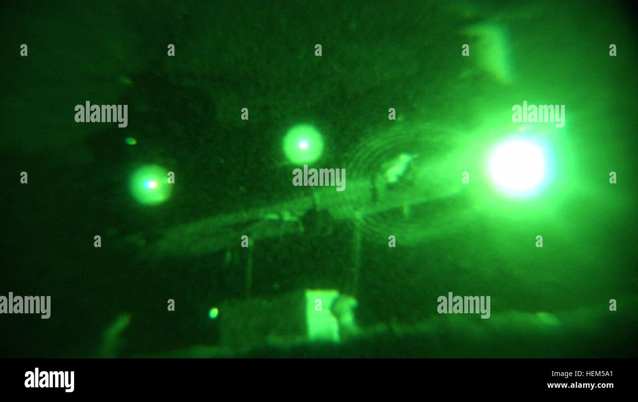 Una Task Force Saber, 82a combattere la Brigata Aerea CH-47 Chinook vola come gli equipaggi di terra il gancio di un generatore di grandi dimensioni per il pesante-sollevamento di aeromobili in avanti su una base operativa Joyce, Afghanistan. A tarda notte airlifts Chinook per offrire forniture fondamentali sono comuni in Afghanistan orientale, dove un terreno accidentato spesso vieta di rialimentazione avamposti in remoto tramite la terra di convogli. Consegna pesanti 574963 Foto Stock