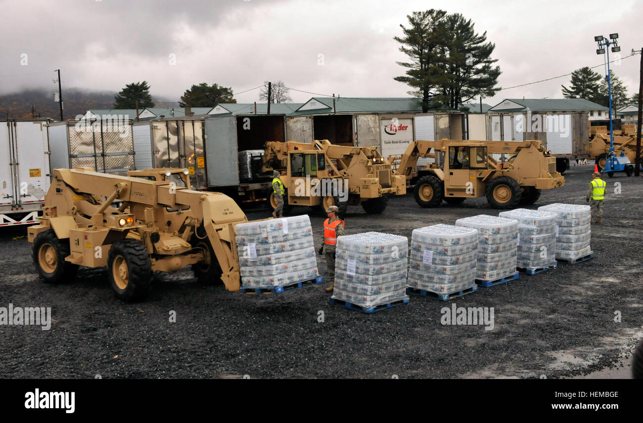 Con la missione di portare acqua e cibo ai Kintnersville, Pa., Pennsylvania Guardmembers nazionale andare al lavoro il caricamento dei rimorchi di M915A5 Freightliners del 131Azienda di Trasporti a Fort Indiantown Gap, Pa., Ottobre 31, 2012. I pallet sono allineati e poi caricato sul retro del camion tramite carrelli elevatori. Ciascun pallet contiene circa 1728 bottiglie di acqua. PA Guardia Nazionale offre a Kintnersville nell ora del bisogno 121031-A-IX878-110 Foto Stock