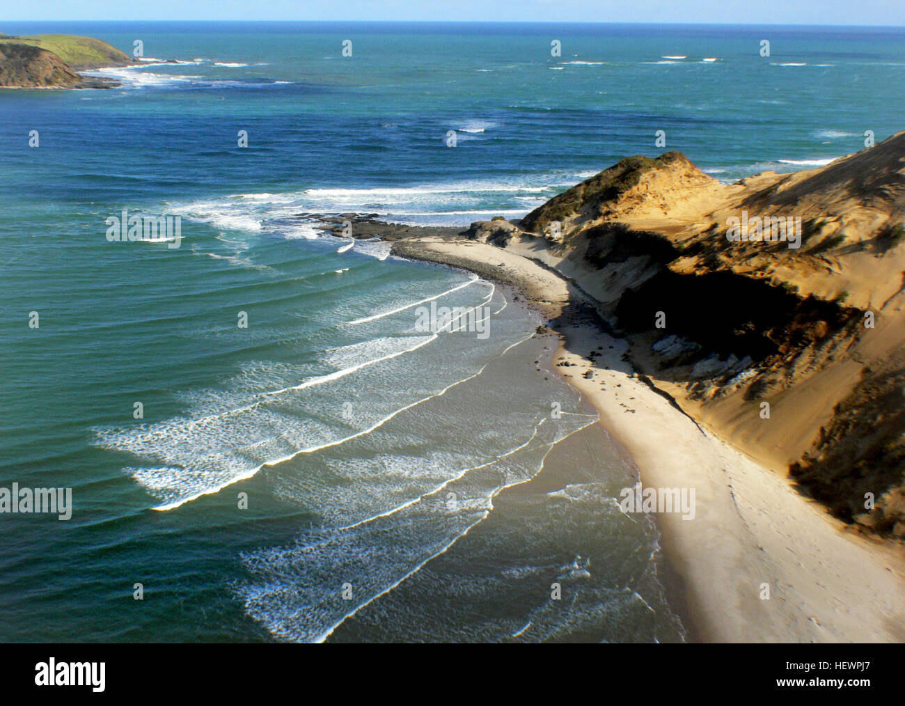 Questa fotografia cattura la bellezza serena del Mare di Tasman e del Porto di Hokianga. Conosciuta per la sua splendida costa, l'immagine raffigura la tranquilla costa del mare, enfatizzando i paesaggi naturali e l'ambiente costiero dell'Isola del Nord della nuova Zelanda. Foto Stock