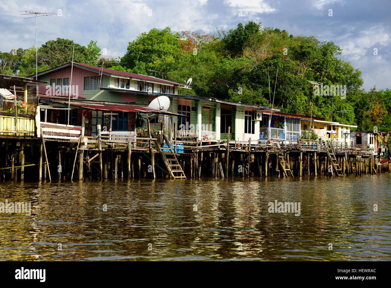 Kampong Ayer, il più grande villaggio di palafitte del mondo, ospita 30.000 persone lungo il fiume Sungai Brunei in Brunei. Questo insediamento secolare ha una propria infrastruttura, tra cui scuole, moschee e stazioni dei vigili del fuoco. I taxi d'acqua sono una caratteristica fondamentale della vita quotidiana, fornendo il trasporto attraverso il fiume. Fondata oltre 1.000 anni fa, rimane una parte unica del patrimonio culturale del Brunei. Foto Stock