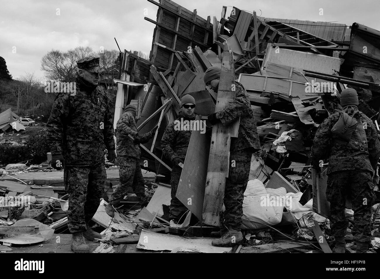 Lt. Gen. Kenneth J. Glueck, III Marine forza expeditionary comandante generale e la Task Force 505 commander, orologi Marines e marinai ordinare attraverso il relitto di case e edifici durante un'operazione di pulizia qui 3 aprile. Glueck ha viaggiato per l'isola di Oshima, uno dei più colpiti aree del Giappone, per vedere Marines e marinai dal trentunesimo Marine Expeditionary Unit, III MEF, che sono state aiutando le autorità di governo locali e del personale in un'operazione di pulizia dell'area. Flickr - DVIDSHUB - Giappone, la strada del recupero (immagine 1 di 6) Foto Stock