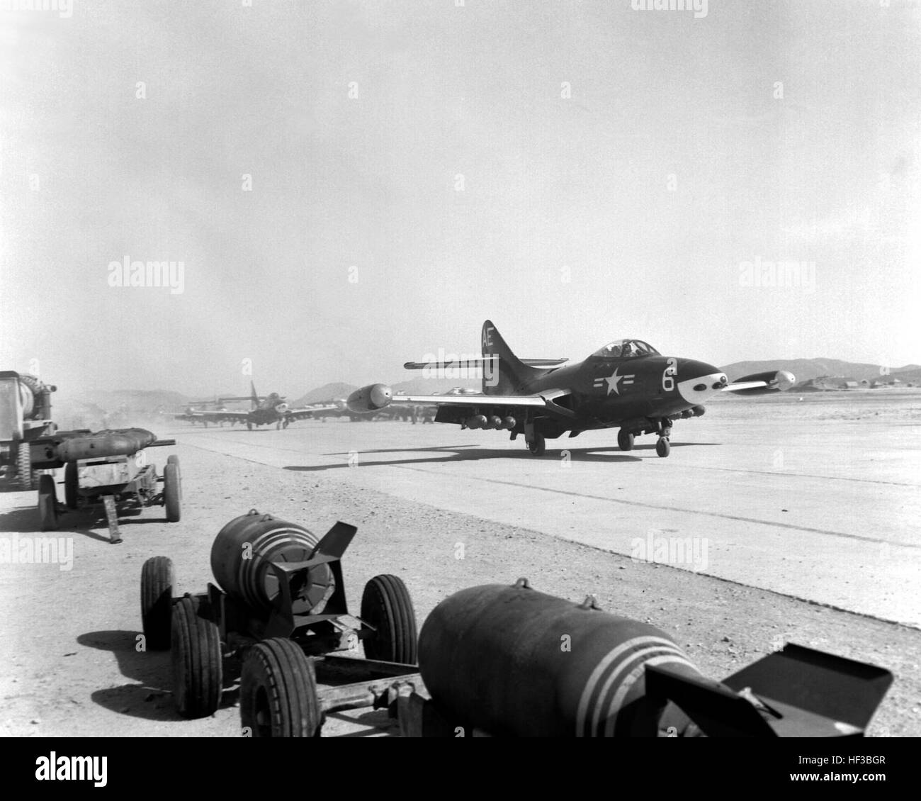 F9F Pantherjets taxi giù la pista in posizione per il decollo contro rosso posizioni in Corea del Nord. NARA il file #: 127-GK-1-A346720 F9F VMF-115 Pohang 1953 Foto Stock