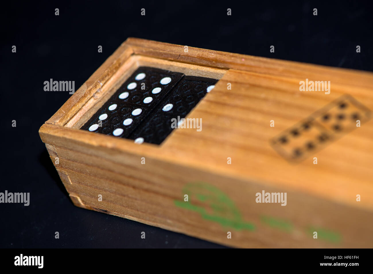 Scatola di legno con pietre di domino Foto Stock