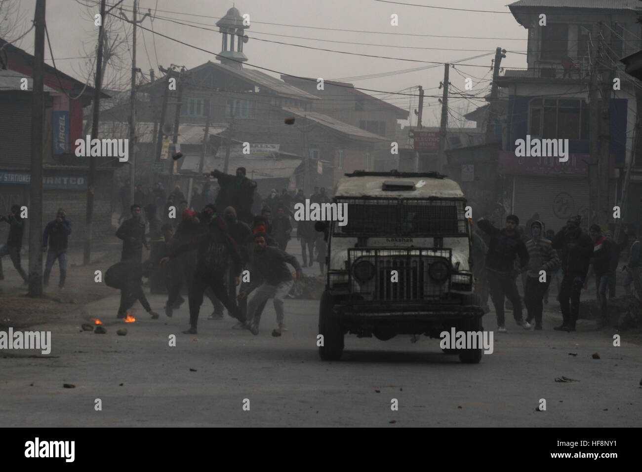 Srinagar, Indiano Kashmir amministrato. Il 30 dicembre 2016.manifestante Kashmir buttare in mattoni a la polizia indiana veicolo, durante una manifestazione di protesta dopo la preghiera del venerdì in . La polizia ha sparato gas lacrimogeni e agglomerati in forma di pellets di fucile per disperdere il Kashmiris manifestanti che si sono riuniti dopo Venerdì pomeriggio preghiere Jamia Masjid, persone inscenato proteste per Jamia Masjid Nowhatta e diverse parti della valle contro la concessione di certificati di domicilio a ovest del Pakistan rifugiati. © Sofi Suhail/Alamy Live News Foto Stock