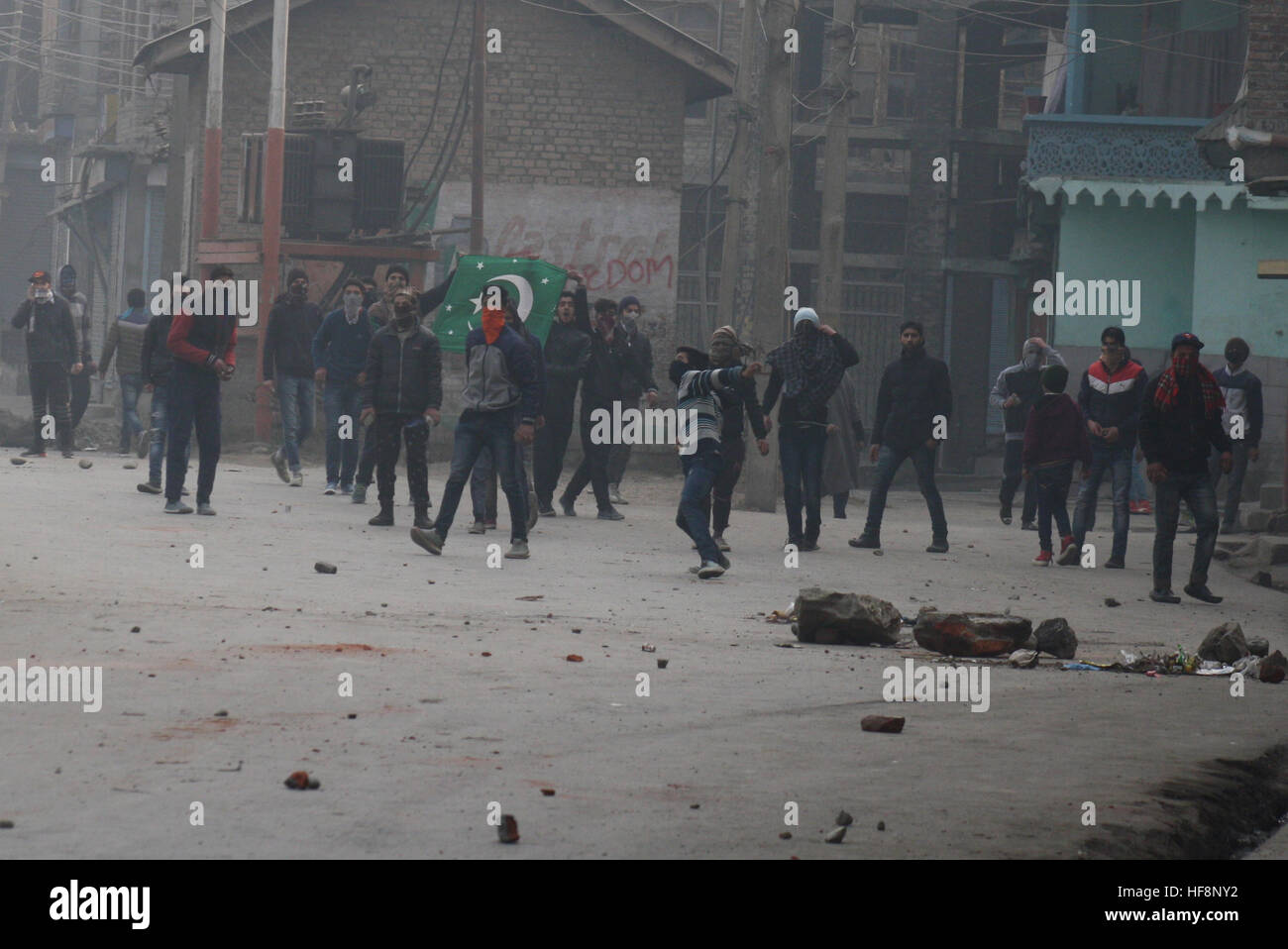 Srinagar, Indiano Kashmir amministrato. Il 30 dicembre 2016.manifestante Kashmir buttare in mattoni a (invisibile )la polizia indiana, durante una manifestazione di protesta dopo la preghiera del venerdì in . La polizia ha sparato gas lacrimogeni e agglomerati in forma di pellets di fucile per disperdere il Kashmiris manifestanti che si sono riuniti dopo Venerdì pomeriggio preghiere Jamia Masjid, persone inscenato proteste per Jamia Masjid Nowhatta e diverse parti della valle contro la concessione di certificati di domicilio a ovest del Pakistan rifugiati. © Sofi Suhail/Alamy Live News Foto Stock