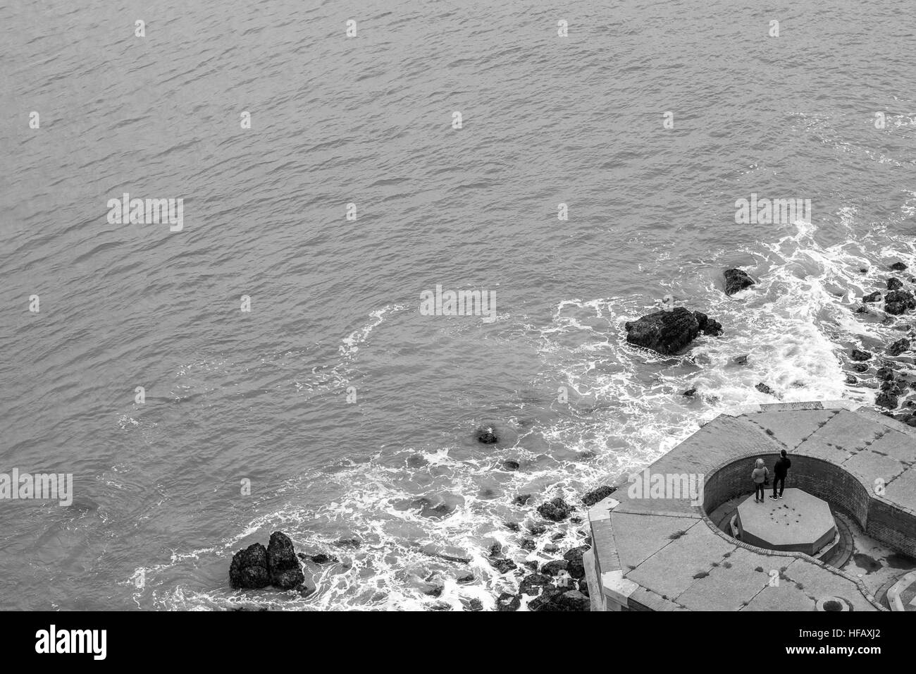 Due persone che si affacciano sulla Baia di San Francisco dalla base del Golden Gate Bridge in un freddo giorno di dicembre. Foto Stock