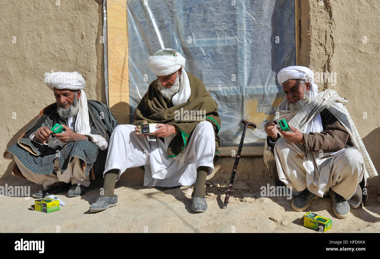 Gli anziani del villaggio di esaminare le Radio fornite da afghano di Polizia Locale in Walan Rabat, provincia di Zabul, Afghanistan, 1 gennaio. Le autoradio abilitare i bambini del villaggio di partecipare a un livello locale radio trasmesso il programma di alfabetizzazione. (U.S. Foto di Marina di Massa lo specialista di comunicazione 2a classe Jon Rasmussen / Non rilasciato) afgano Polizia Locale 120101-N-CI175-055 Foto Stock