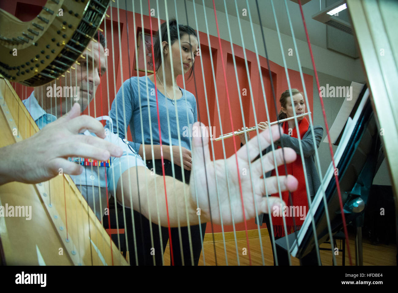 Senior Master Sgt. Eric A. Sabatino, arpa solista per la United States Air Force Band, originariamente da Evansville, Ind. funziona con Australia Eltham High School symphonic band flutists Lauren Scalzo (centro) e Anna Telfer (a destra) durante un mini-clinic presso la Air Force Band hangar su base comune Anacostia-Bolling. Due bande rafforzamento strategico, legami militari attraverso la musica 141208-N-WY366-871 Foto Stock