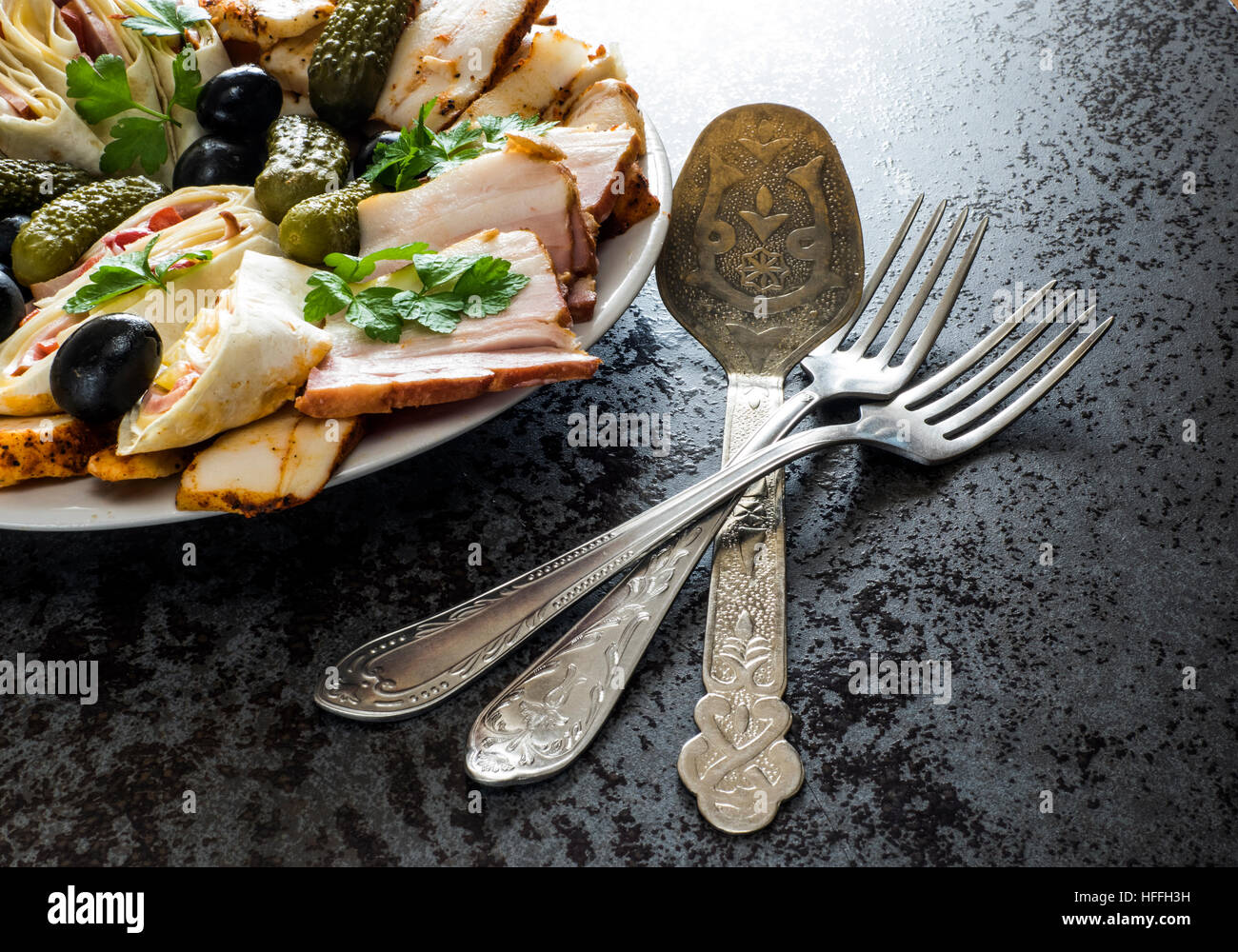 Piatto di Salumi con prosciutto, pancetta, olive e sottaceti Foto Stock