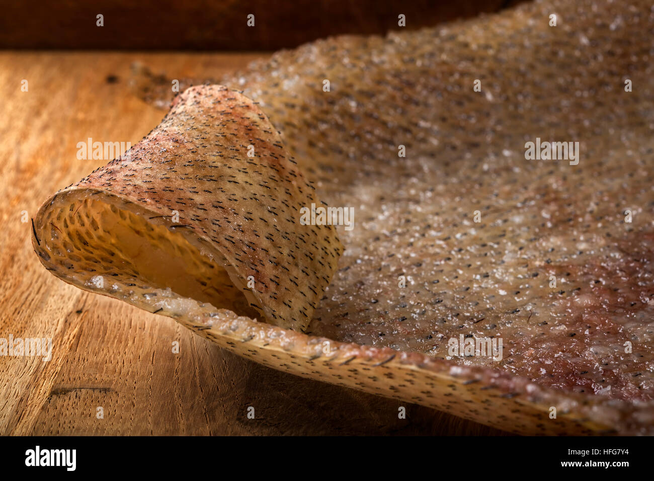 Close up di carne di maiale affumicata pelle (rumeno tradizionale cibo - soric) su uno sfondo di legno Foto Stock