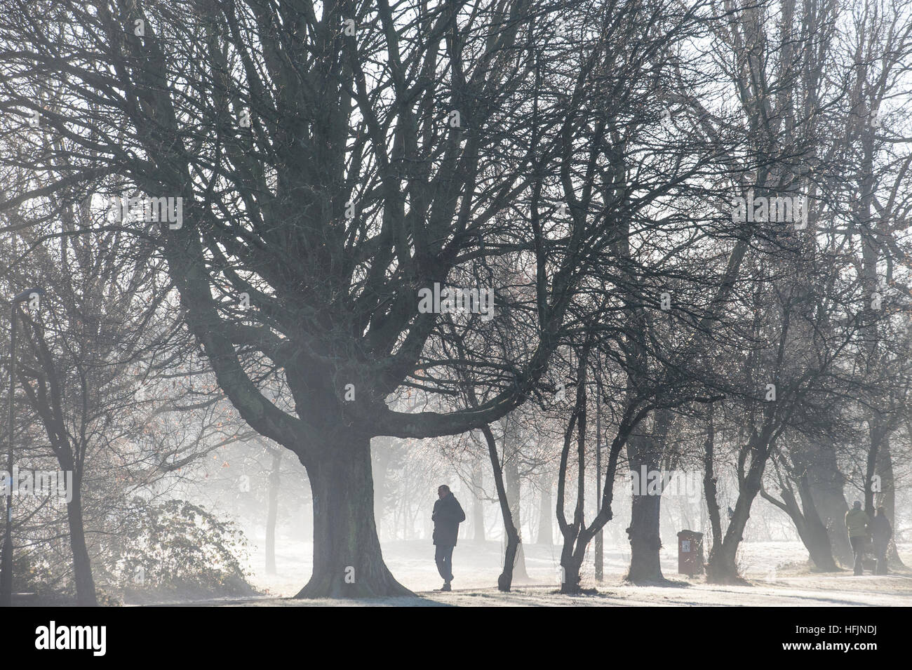 Un padre camminando su un freddo gelido e giorno Foto Stock