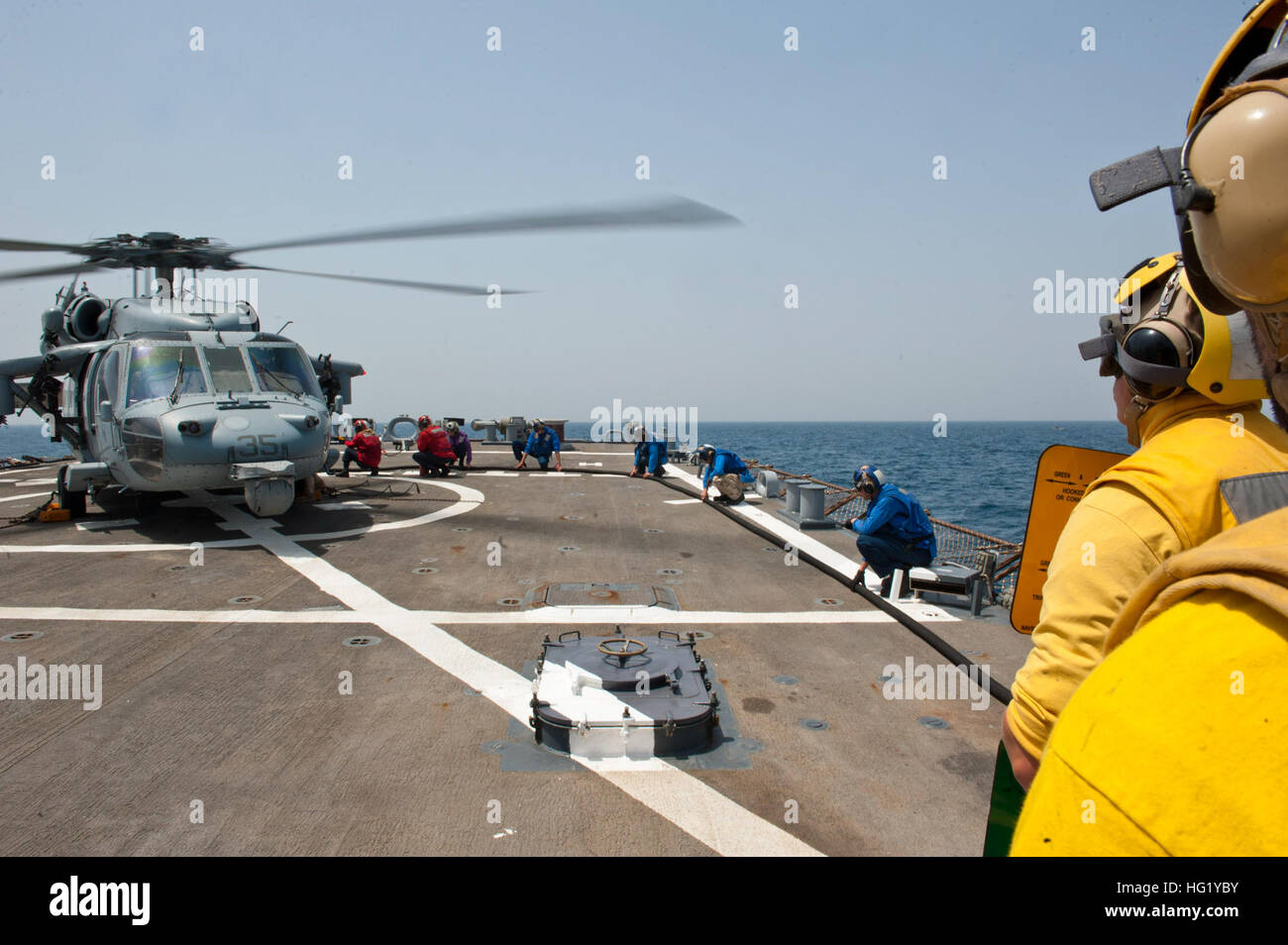 Stati Uniti I marinai di fare rifornimento di carburante un MH-60S Seahawk elicottero assegnato al mare in elicottero Combat Squadron (HSC) 26 sul ponte di volo del missile destroyer USS Arleigh Burke (DDG 51) nel Golfo Persico Aprile 19, 2014. Il Arleigh Burke distribuito come supporto di le operazioni di sicurezza marittima e di teatro la cooperazione in materia di sicurezza gli sforzi negli Stati Uniti Quinta Flotta area di responsabilità. (U.S. Foto di Marina di Massa lo specialista di comunicazione 2a classe Carlos Vazquez II/RILASCIATO) USS Arleigh Burke operazioni 140419-N-WD757-122 Foto Stock