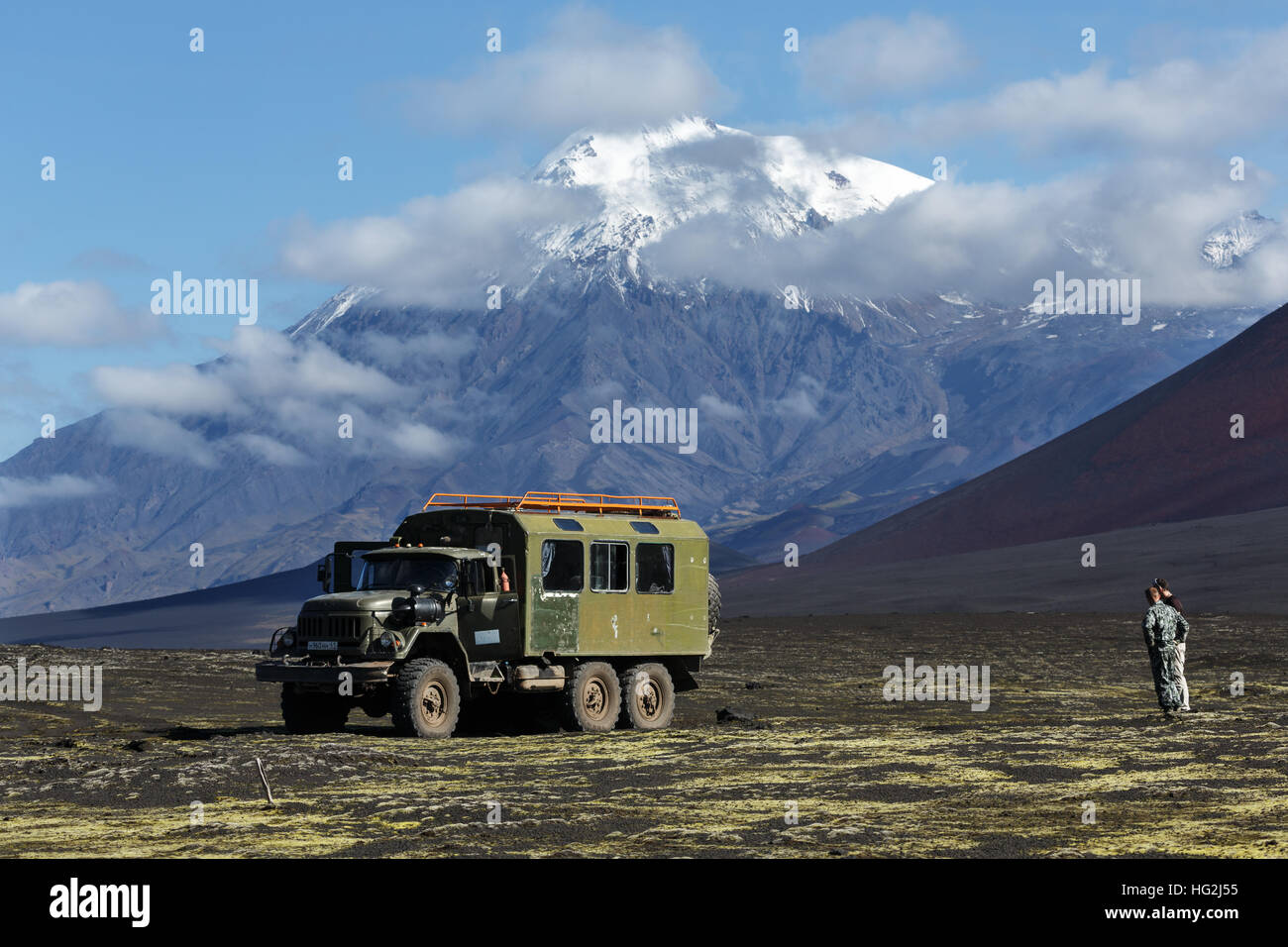 Vecchio estrema sovietica spedizione carrello ZIL-131 (sei ruote motrici) sulla scoria vulcanica campo sullo sfondo della splendida vulcano. La Russia, penisola di Kamchatka, Foto Stock