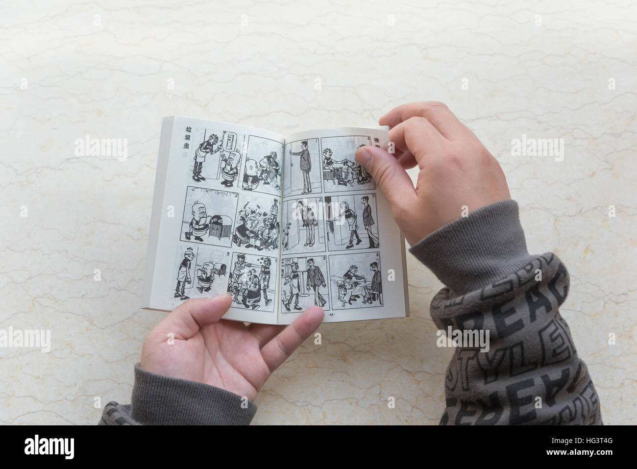 ZhongShan China-January 4:l'uomo la lettura di un libro a fumetti denominate old master Q il 4 gennaio 2017.Old master Q è un popolare Hong Kong Fumetto creato da Alfonso W Foto Stock