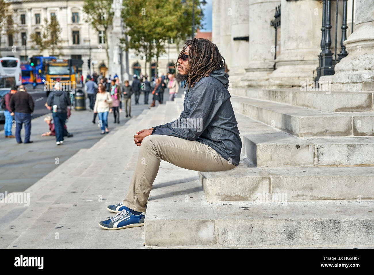 Uomo nero. Contemplando l'uomo. dreadlocks. Rastafarian. Da soli nella città. Foto Stock