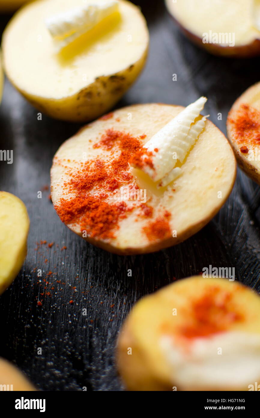 Patate con burro e pepe rosso, con bassa profondità di campo Foto Stock