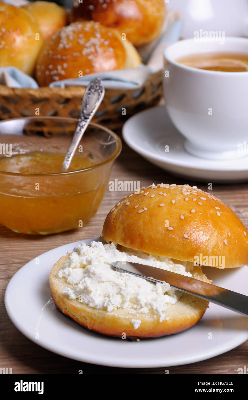 Tagliare la pagnotta con il formaggio su un piatto e un coltello Foto Stock