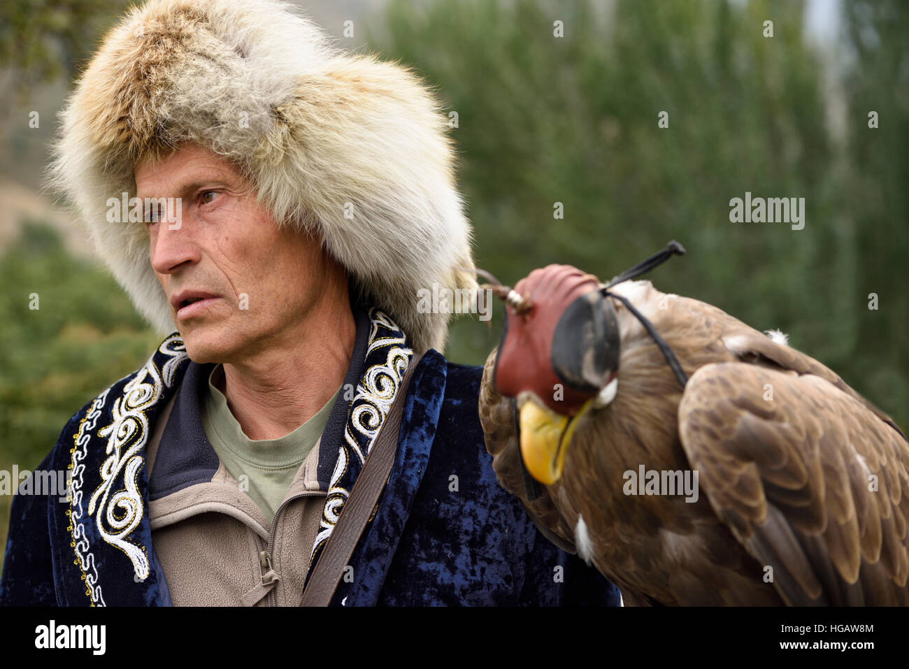 Eagle hunter in abiti tradizionali con hooded White Tailed Eagle Sunkar santuario Almaty Kazakhstan Foto Stock