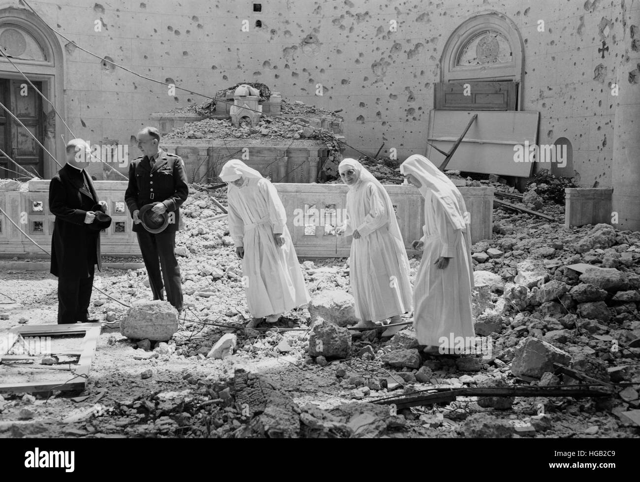 Le suore cattoliche sondaggio le rovine di una cappella distrutta, 1943. Foto Stock