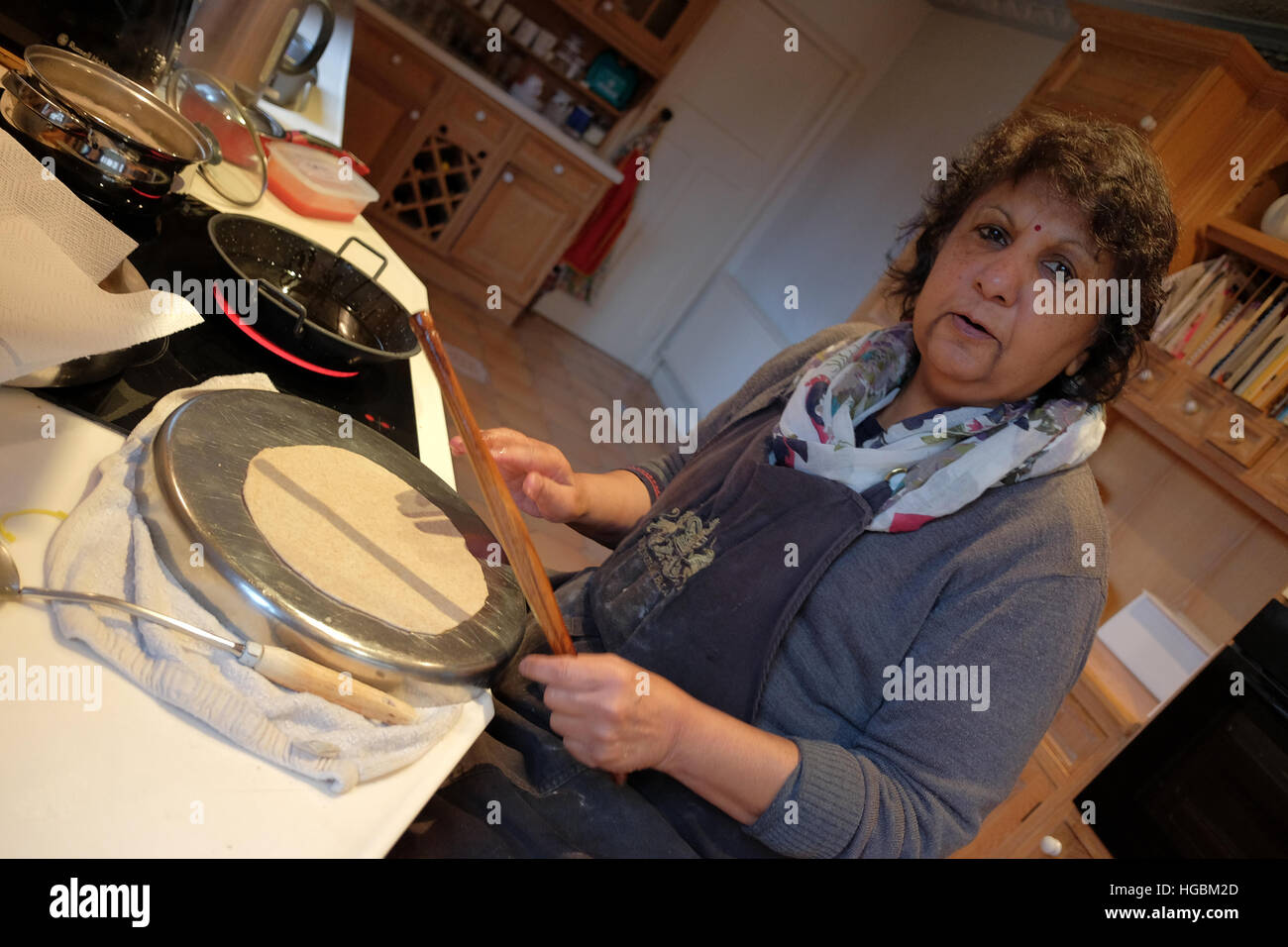 Una donna asiatica cucinare cibo indiano in una moderna cucina Foto Stock