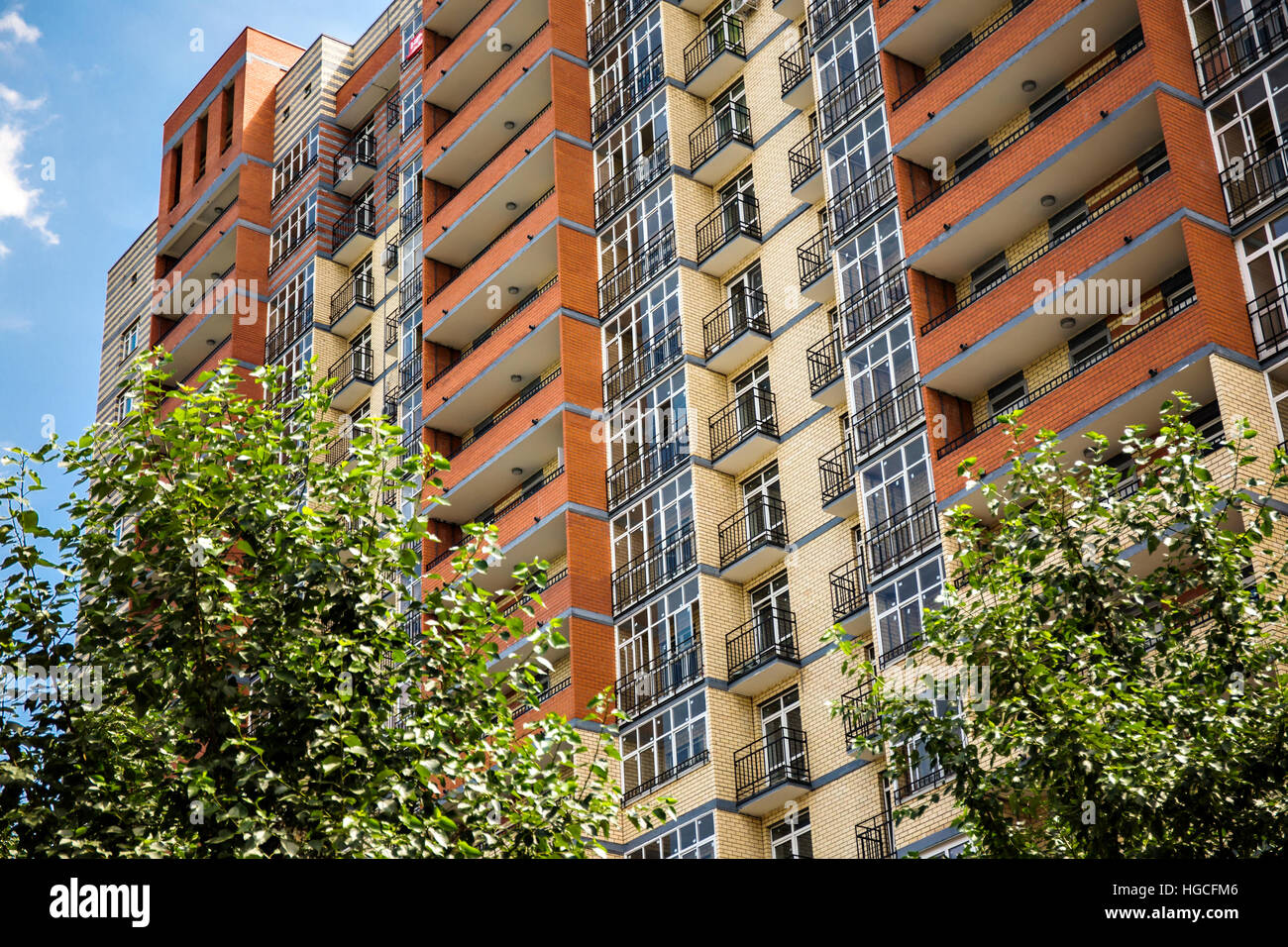 Nuovo e moderno appartamento multipiano edificio con albero in primo piano Foto Stock
