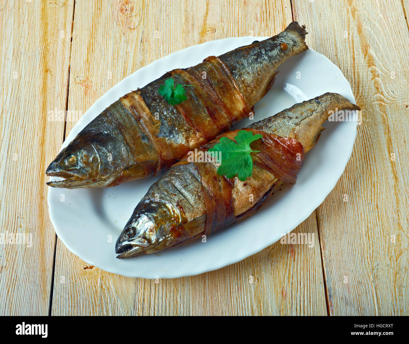 Trote avvolto in pancetta con rosmarino. Foto Stock