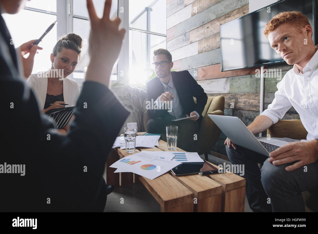 Un gruppo di giovani uomini di affari che in una riunione presso l'ufficio. Discutere di nuove idee di business. Foto Stock