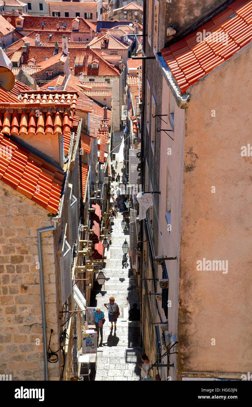 I pedoni a camminare in una strada stretta nelle vecchie mura della città di Dubrovnik, Croazia - patrimonio UNESCO. Foto Stock