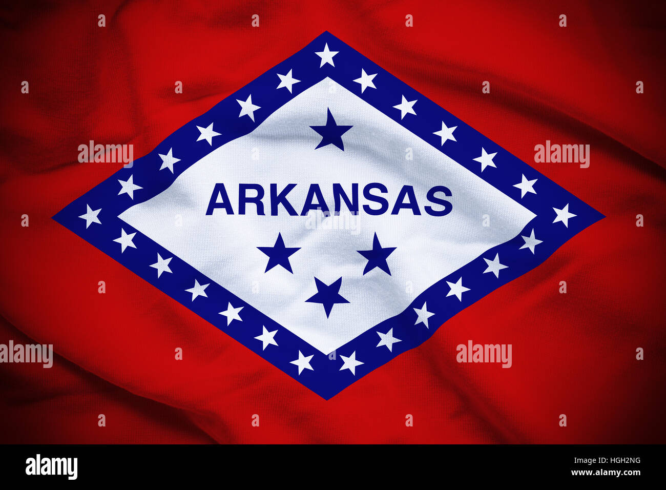 E ondulato increspato bandiera nazionale di Arkansas sfondo. Foto Stock