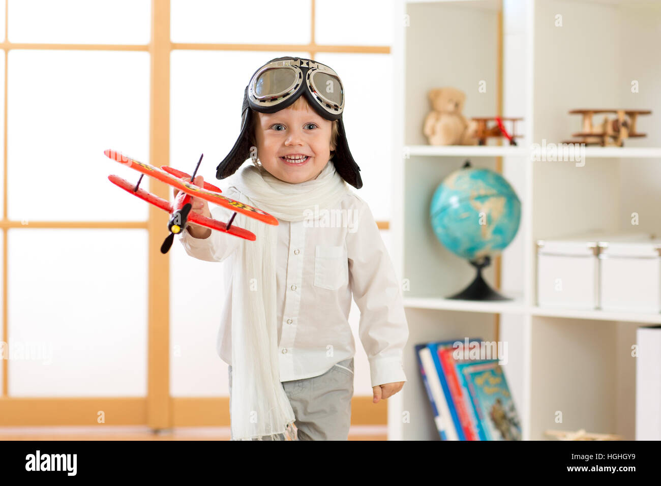 Happy Child boy gioca con aeroplano giocattolo e sogna di diventare pilota Foto Stock