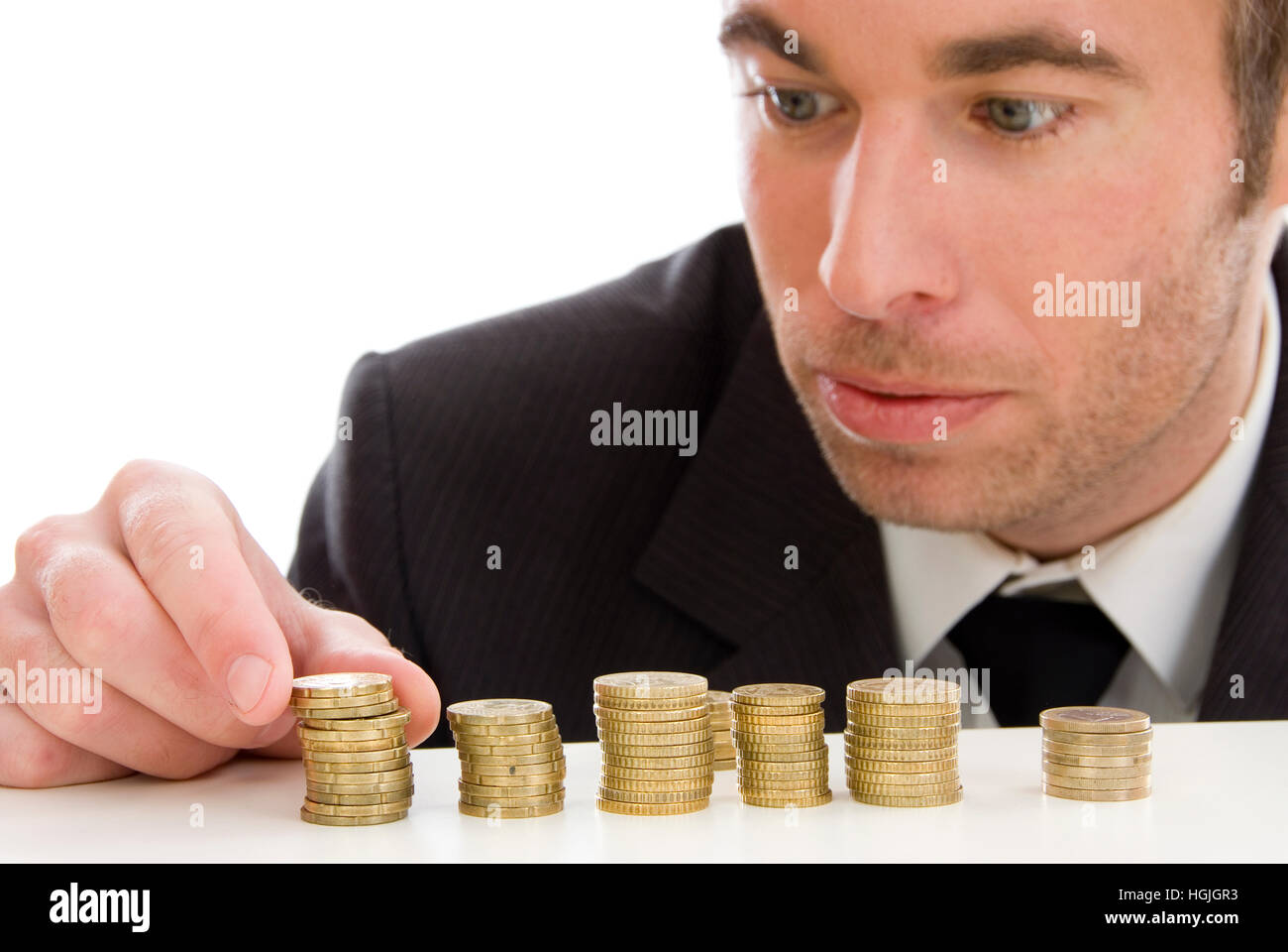 Imprenditore con monete metalliche in euro Foto Stock
