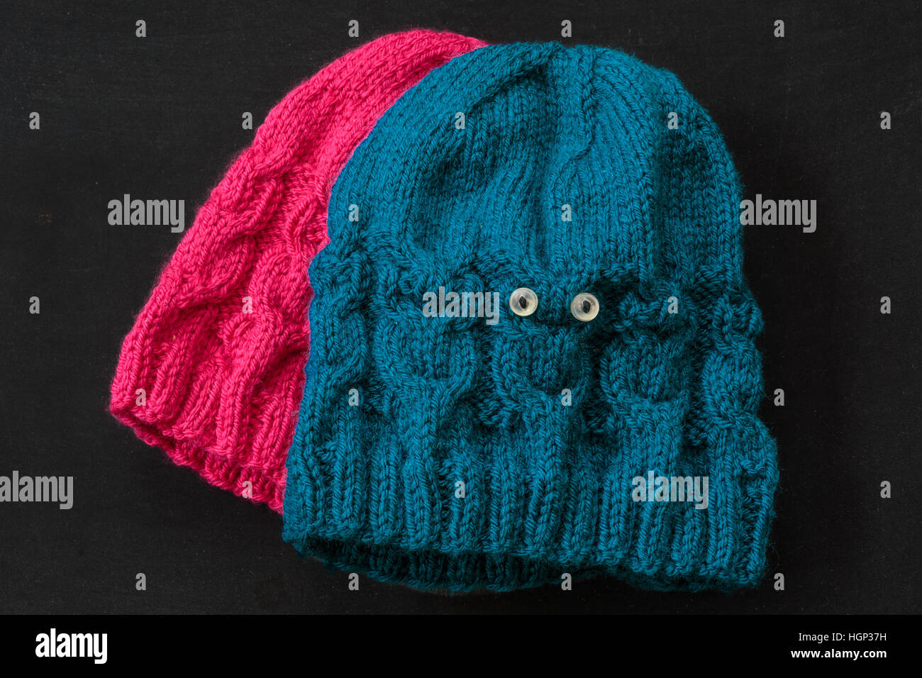 In casa per bambini cappelli a maglia con il design del cavo delle civette. Foto Stock