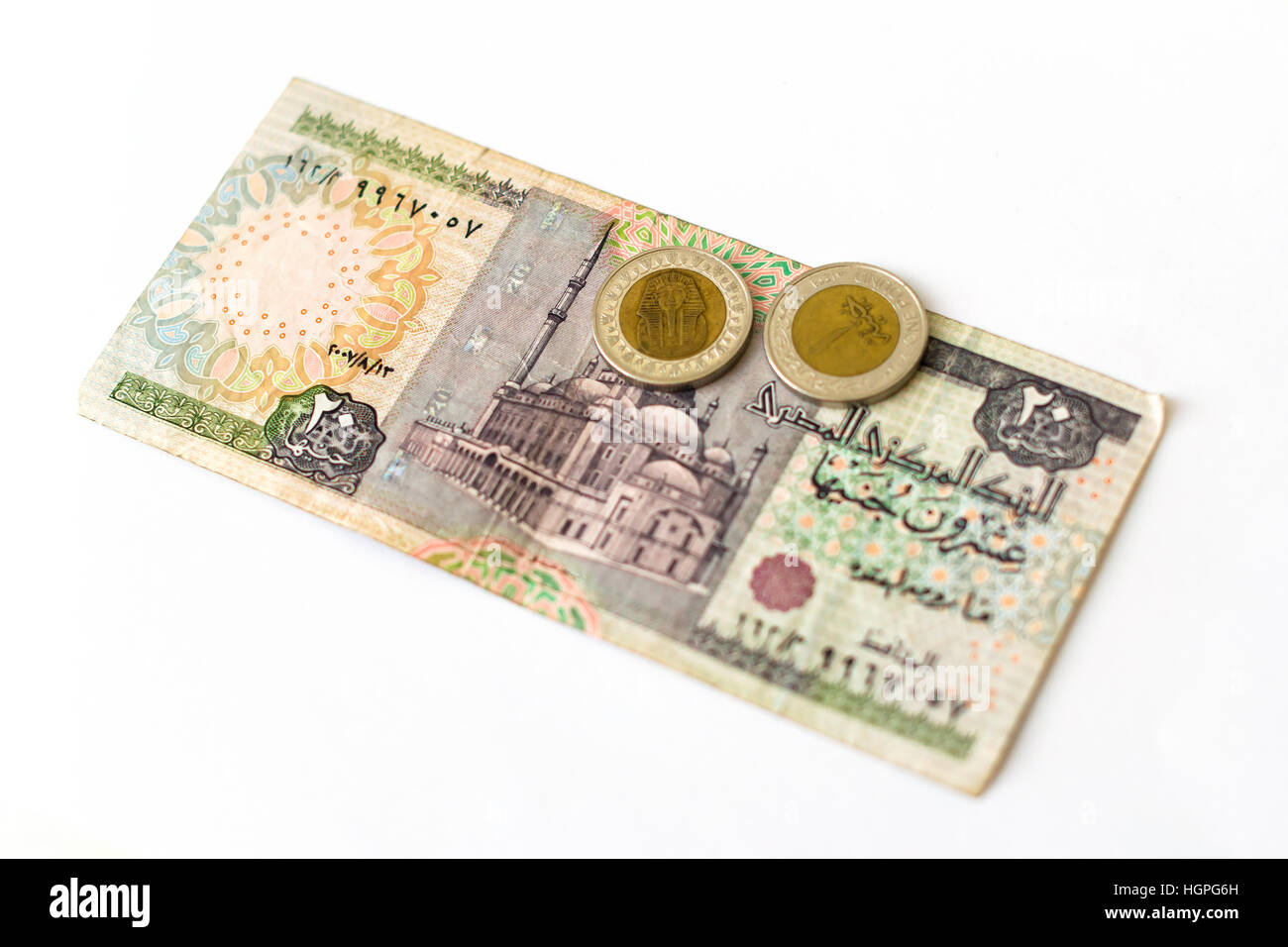 20 Sterline egiziane, vecchi tagli delle banconote di venti EGP con moschea. Coin 1 libbra di Sphinx. Simbolo di valuta Egitto di ricchezza e di investimento. Foto Stock