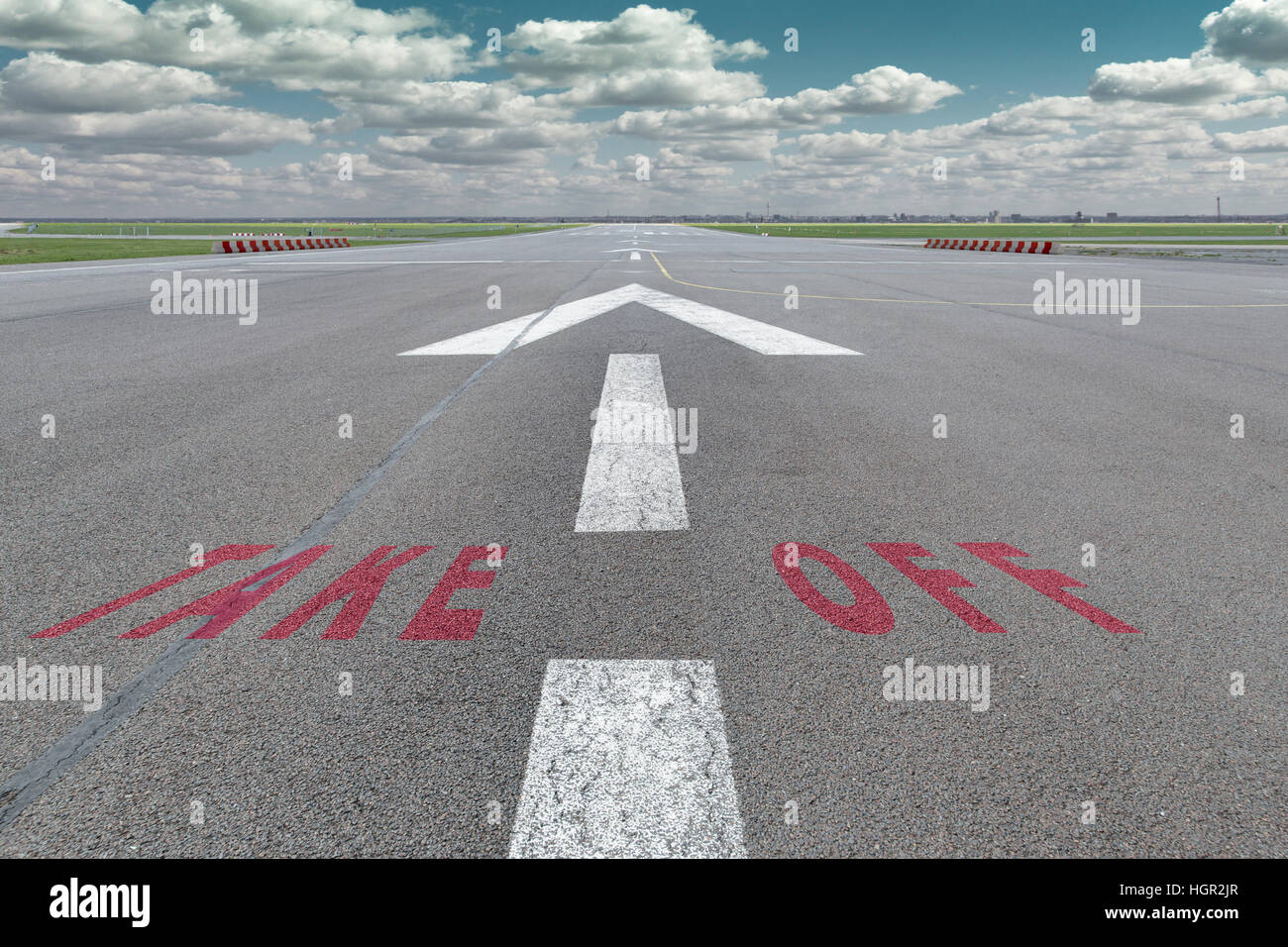 Pista di aeroporto con la freccia di orientamento magenta e togliere le lettere dipinti sulla superficie. Vi è un divario fore proprio contenuto tra le lettere. Foto Stock
