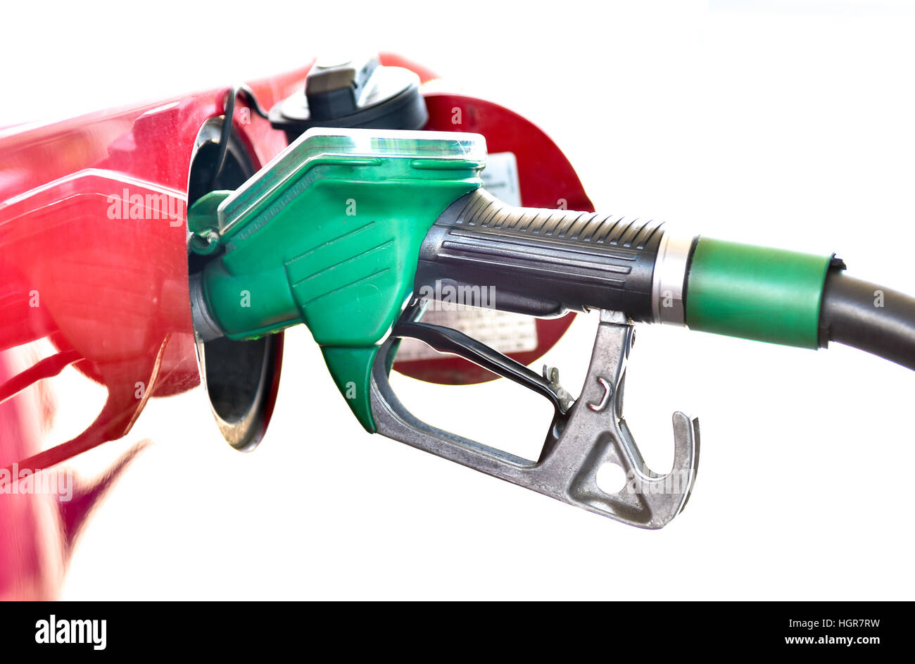 Il rifornimento di un'auto rossa presso la stazione di gas. Un carrello viene riempito con carburante diesel o benzina verde con ugello. Isolato su bianco. Foto Stock