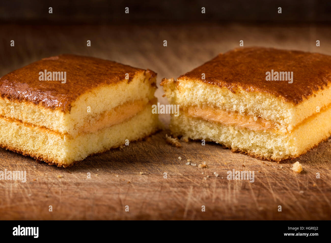 Pan di Spagna con crema di frutta su sfondo di legno Foto Stock