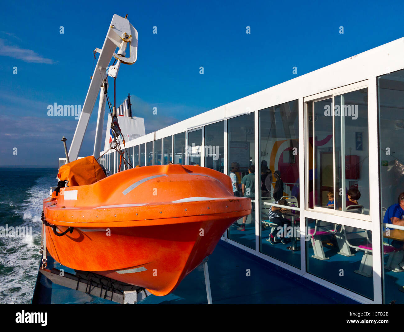 Orange scialuppa di salvataggio sul ponte di un traghetto passeggeri in mare nel Canale Inglese UK Foto Stock