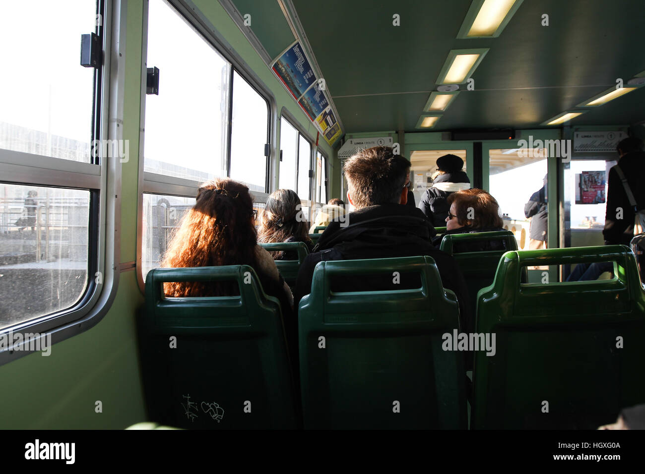 Passeggeri prendono i loro posti a sedere su un acqua servizio di autobus dal Lido al centro di Venezia. Foto Stock