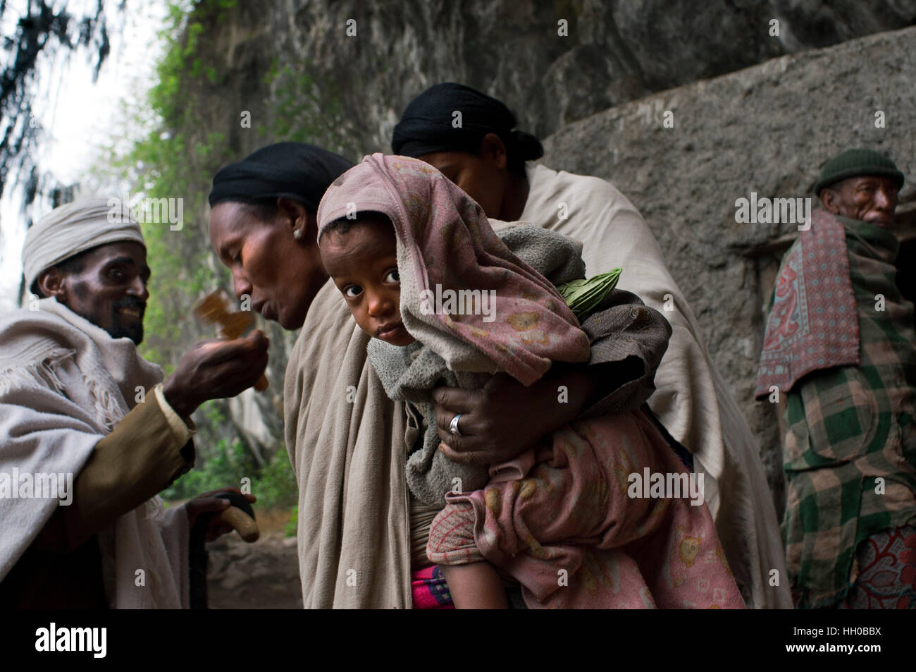 Laboratorio Nakuto chiesa rupestre, Amhara Region, Lalibela, Etiopia. Una donna bacia il cuz di un sacerdote nella chiesa di Nakuto Lab, nella periferia di Lalibel Foto Stock