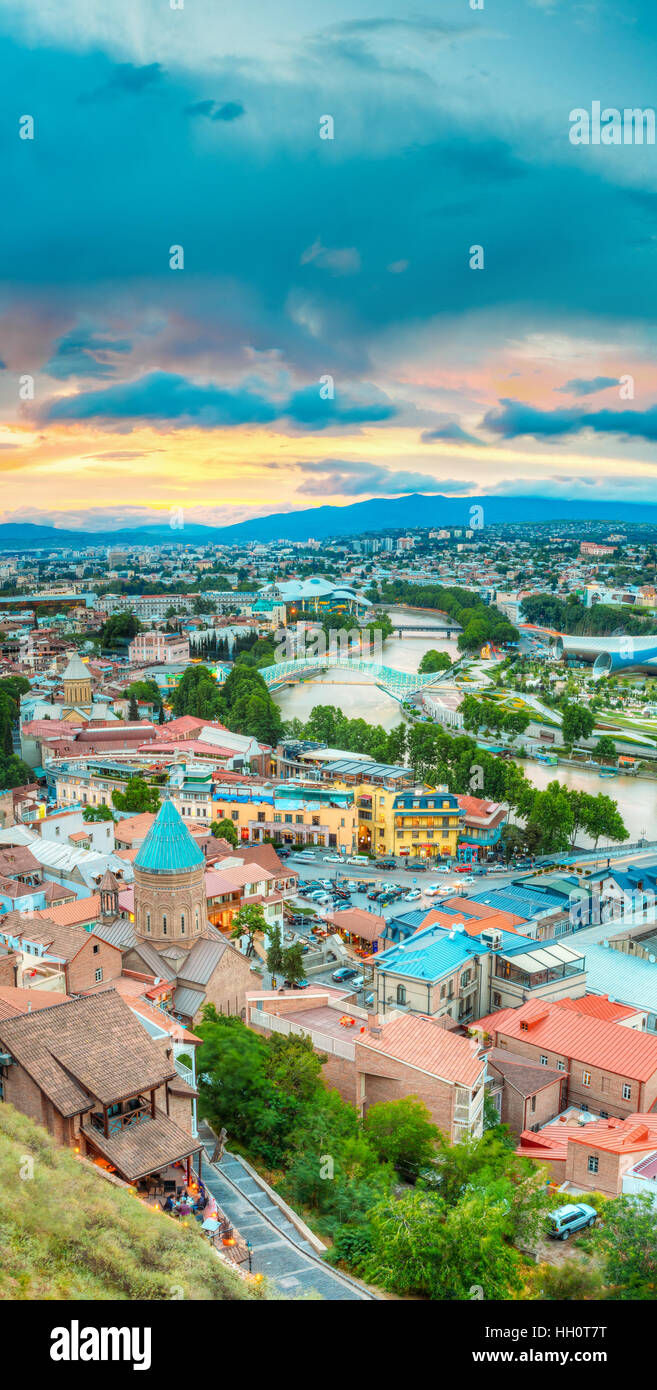 Vista superiore della vecchia città colorate e Kura fiume Mtkvari sotto i ponti in estate Tbilisi, Georgia Beautiful Scenic Sunset Sunrise Alba cielo nuvoloso indietro Foto Stock
