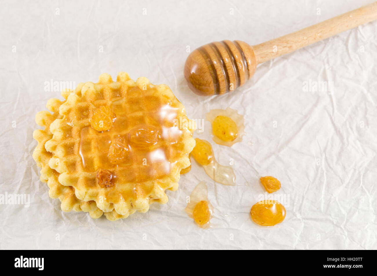 Cotta golden waffle cookies e il dolce miele Foto Stock