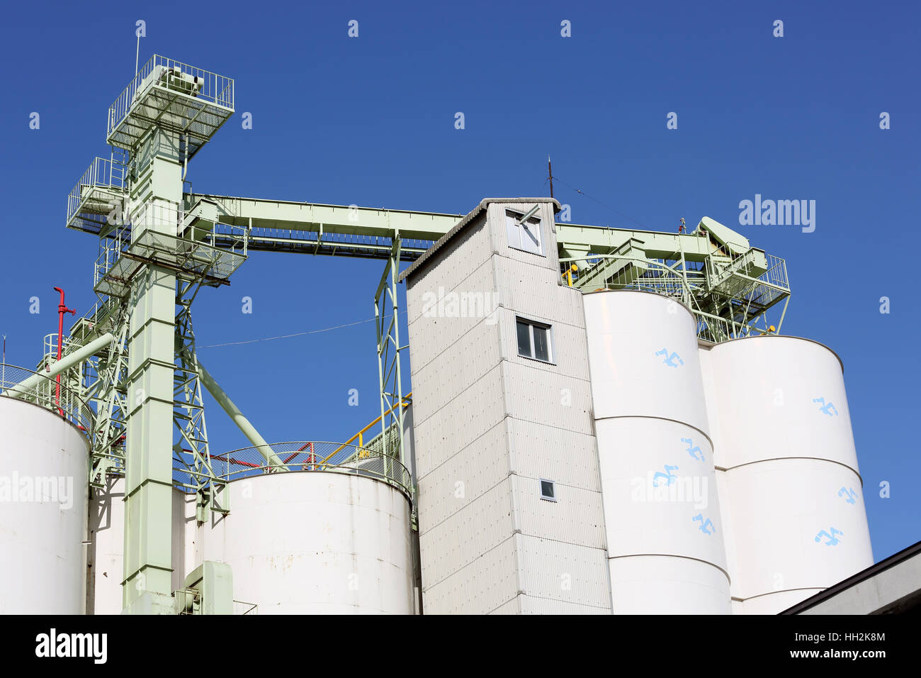 Magazzini industriali e silo di storage contro il cielo blu chiaro Foto Stock