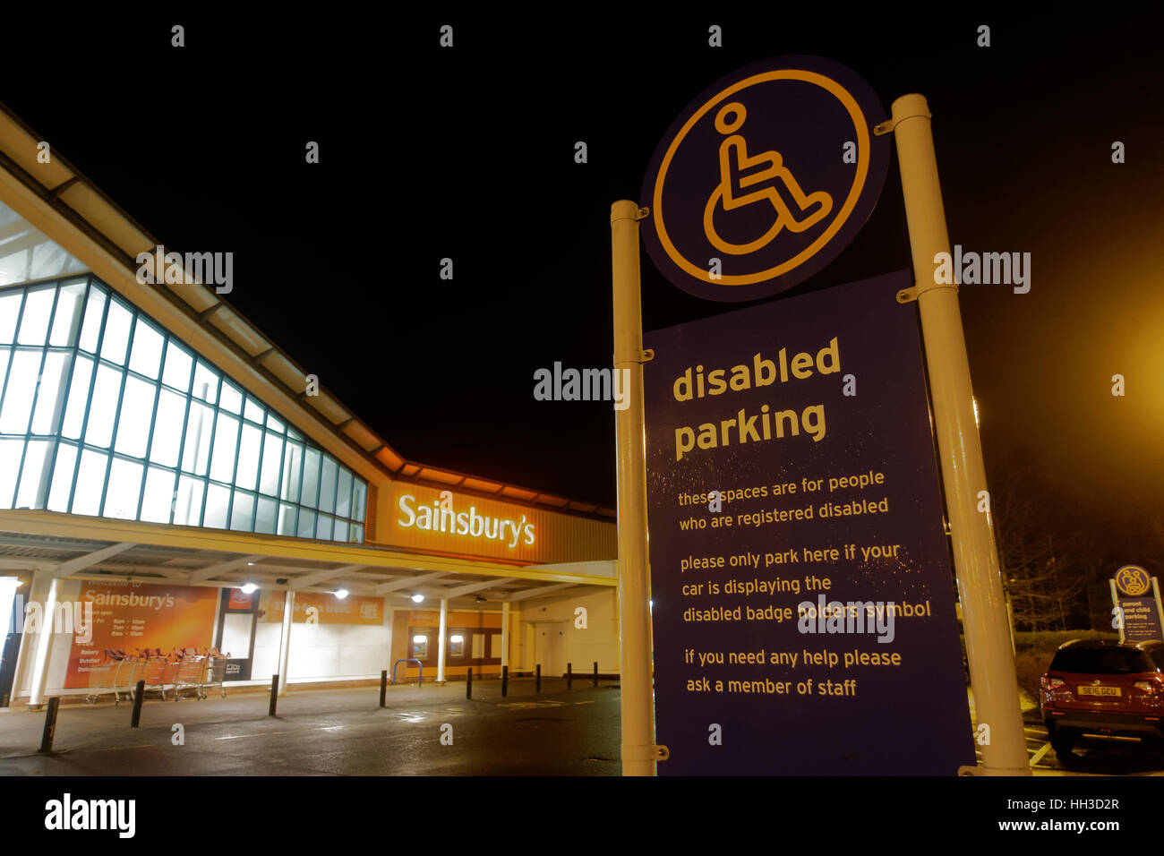 Sainsbuty dei disabili in segno di parcheggio di notte Great Western Retail Park Foto Stock