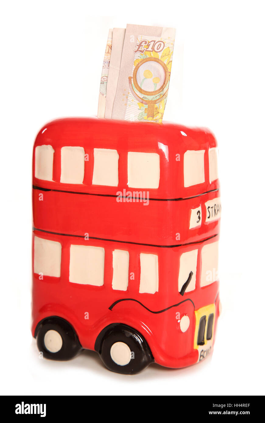 London bus rosso ornamento casella di denaro con dieci pound nota intaglio Foto Stock