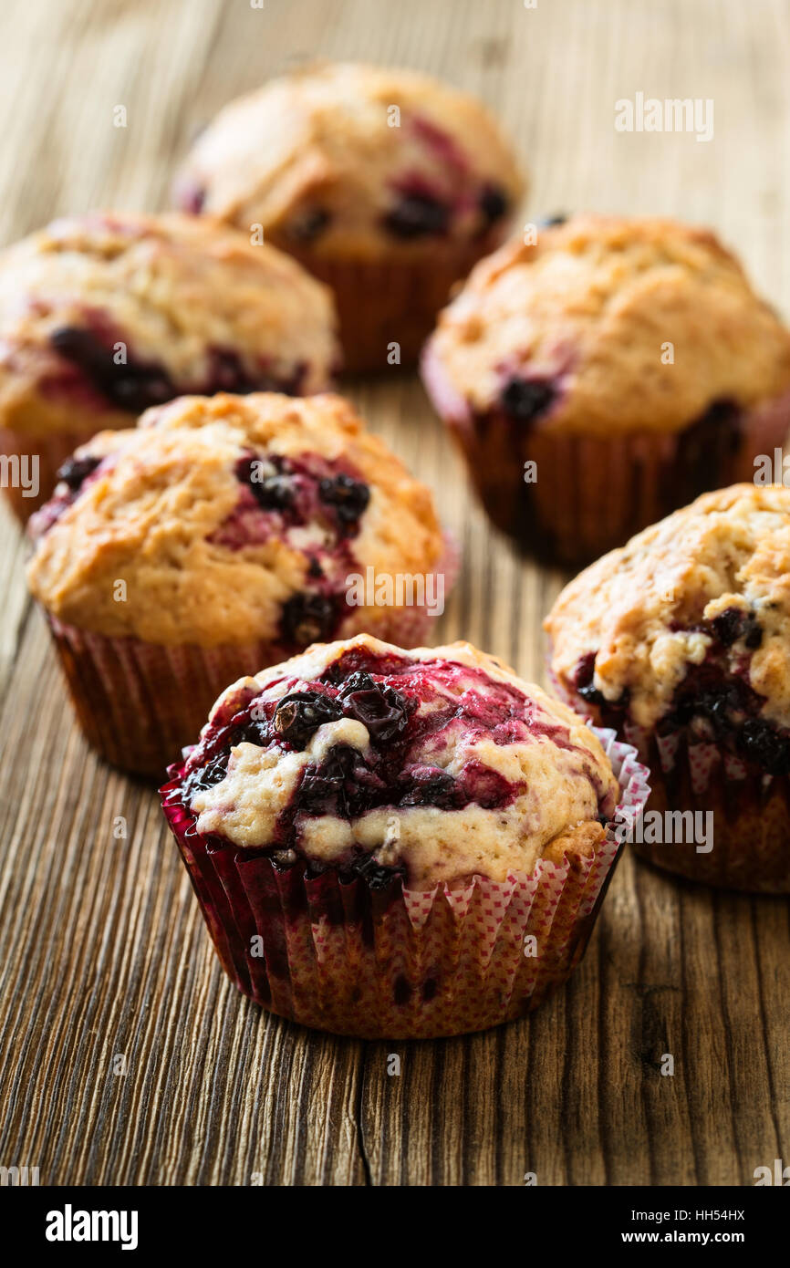 Nero in casa berry muffin. Muffin con ribes nero per una sana prima colazione a tavola in legno rustico Foto Stock